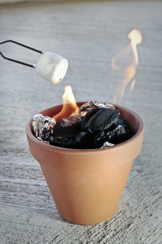 Put charcoal in a foil lined terra cotta pot for table top s'mores! Perfect summer party idea!