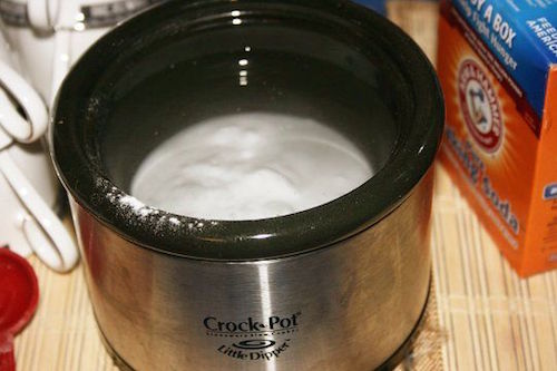 Baking Soda is AWESOME! Mix a few tablespoons of baking soda with water in the bowl of a crockpot or slow cooker. Baking soda seems to literally pull the odors from the air.