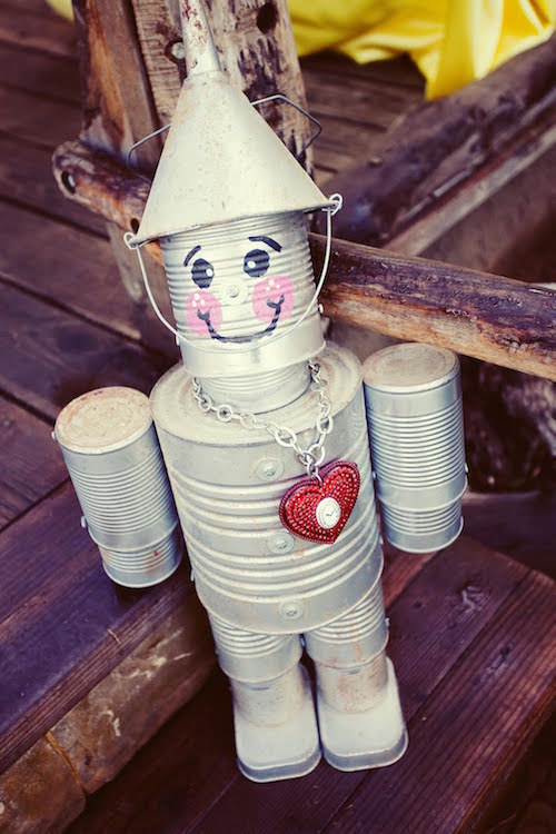 Decorate your entryway with this super cute DIY tin man (with a heart!) using a funnel, various aluminum cans, and silver spray paint!
