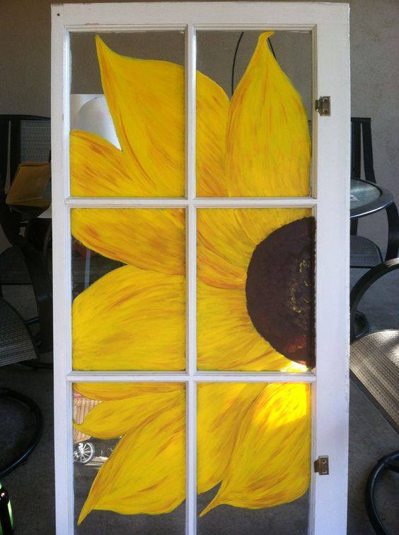 Repurpose an old window by painting a big beautiful sunflower to shine through it! 