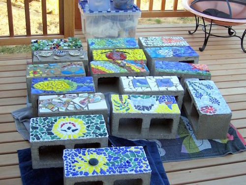 Make cinder block mosaics with sea glass, shells, colored rocks, or anything you can find. Line them around the garden or decorate outside. Fun! 