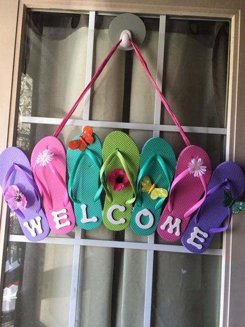 Get sandals from the dollar store, glue them together as shown, add WELCOME letters and other embellishments, then hang it as a summer wreath. Love this easy DIY wreath idea 