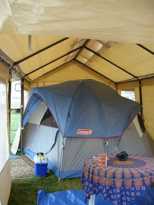 Smart! A tent under a canopy. Additional space is used for living space.
