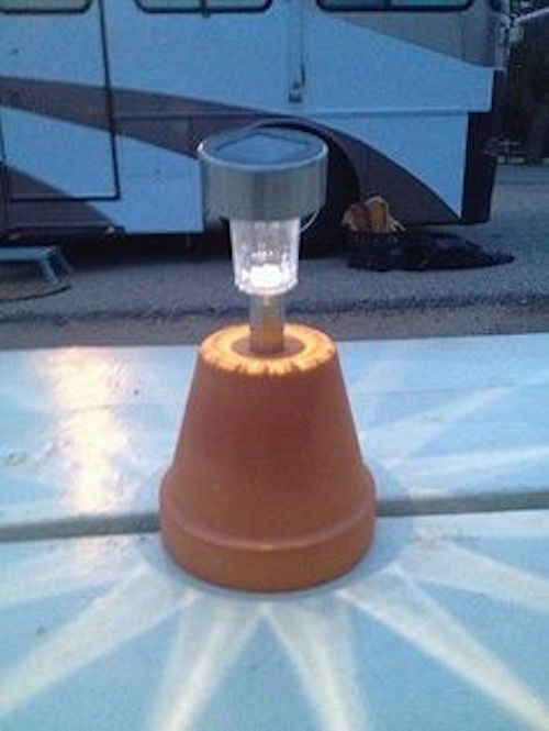DIY camping light - Use a solar light and stick it in an upside down terra cotta pot. Brilliant!