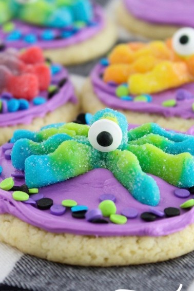 One-Eyed Monster Cookies. 3 ingredient cookies topped with colorful frosting, candy eyes, and monster gummies. Easy cookies to make for Halloween or party.