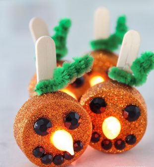 Tea Light Pumpkins - little orange flameless tea lights that stand up and smile! Turn on the candle and the flame becomes the glowing pumpkin nose. They are ADORABLE and so easy to make!