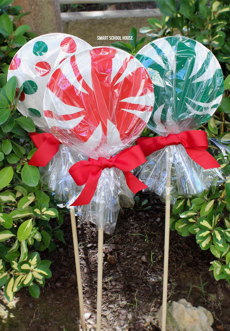 Giant paper plate lollipops for Christmas - ADORABLE! Super cute as a garden Christmas decoration or line your driveway with them! They cost less than a dollar each to make!