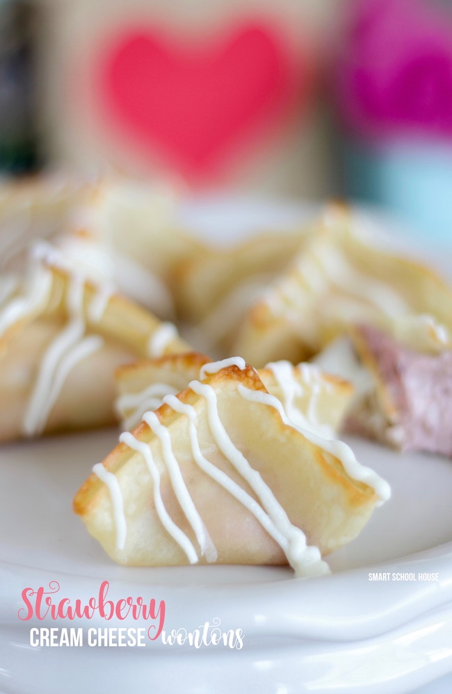 Strawberry Cream Cheese Wontons - 4 ingredient sweet and fluffy strawberry cream cheese mixed with buttery soft baked wonton flavor then drizzled in white chocolate. 