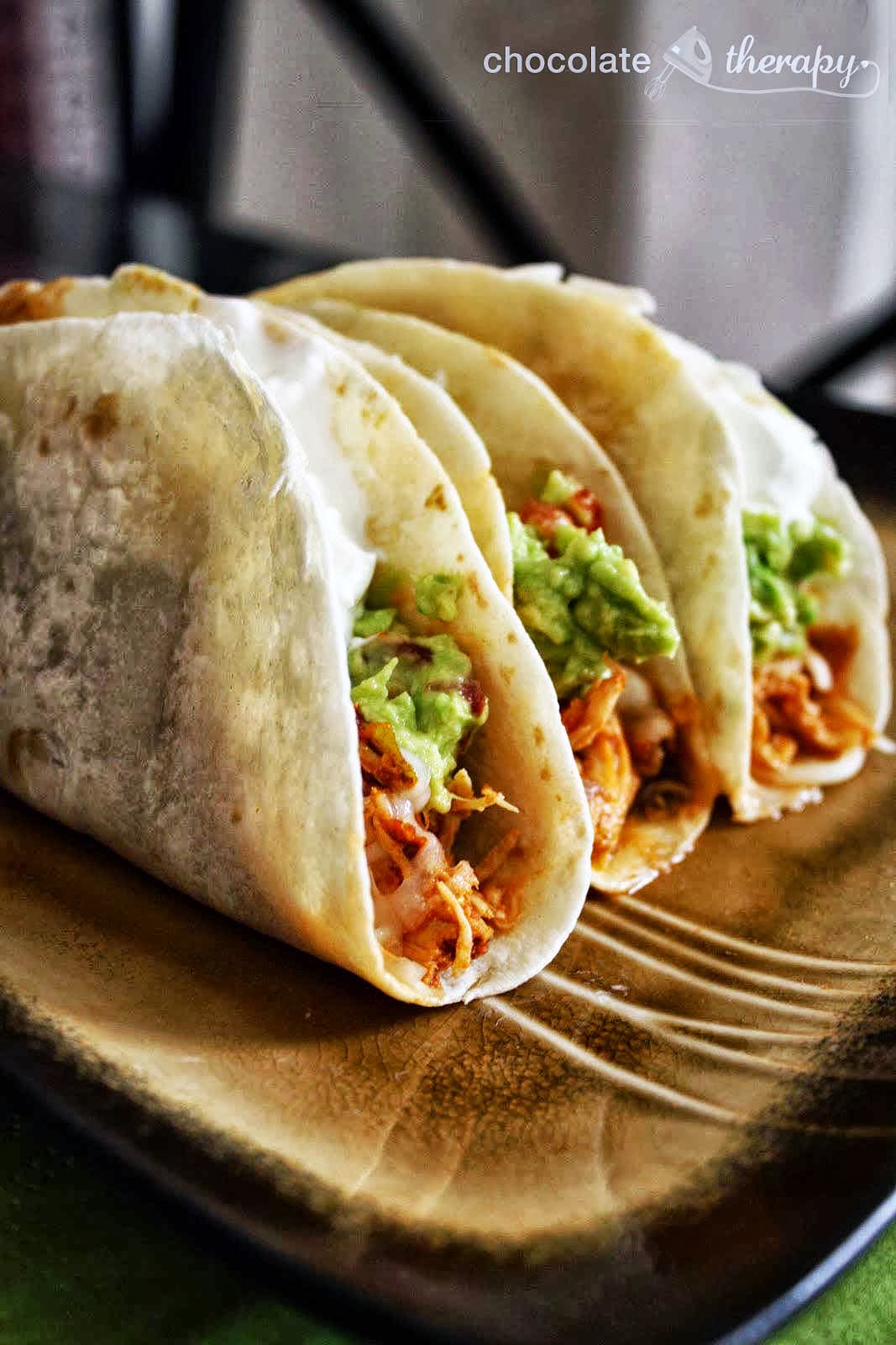 Crockpot Chicken Tacos - These simple pulled chicken tacos are made with a jar of salsa and taco seasoning. Put in the crock pot in the morning and enjoy the day of sun and play while it cooks.