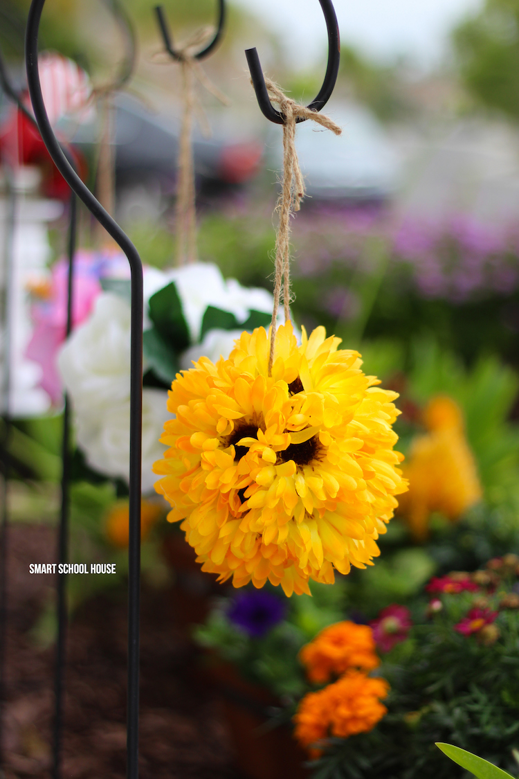 Make flower pomanders with wiffle balls in about 10 minutes!! Hang the sunflowers around your home or use them for party decor. Easy and stunning! These are also called flower kissing balls. You're never going to belive how quick and easy this DIY decor craft is.