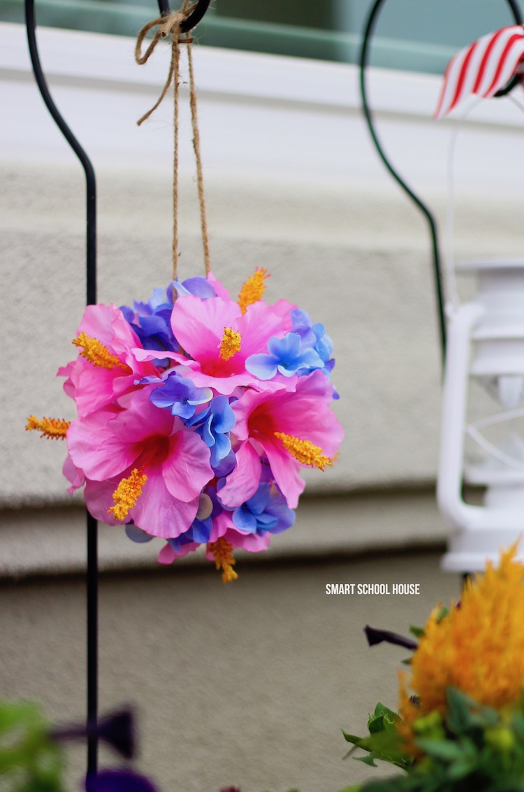 Tropical flower ball using hibiscus and hydrangea. Make these flower pomanders with wiffle balls in about 10 minutes!! Easy, stunning and so tropical looking! These would be excellent for a beach wedding too. You're never going to belive how quick and easy this DIY decor craft is.
