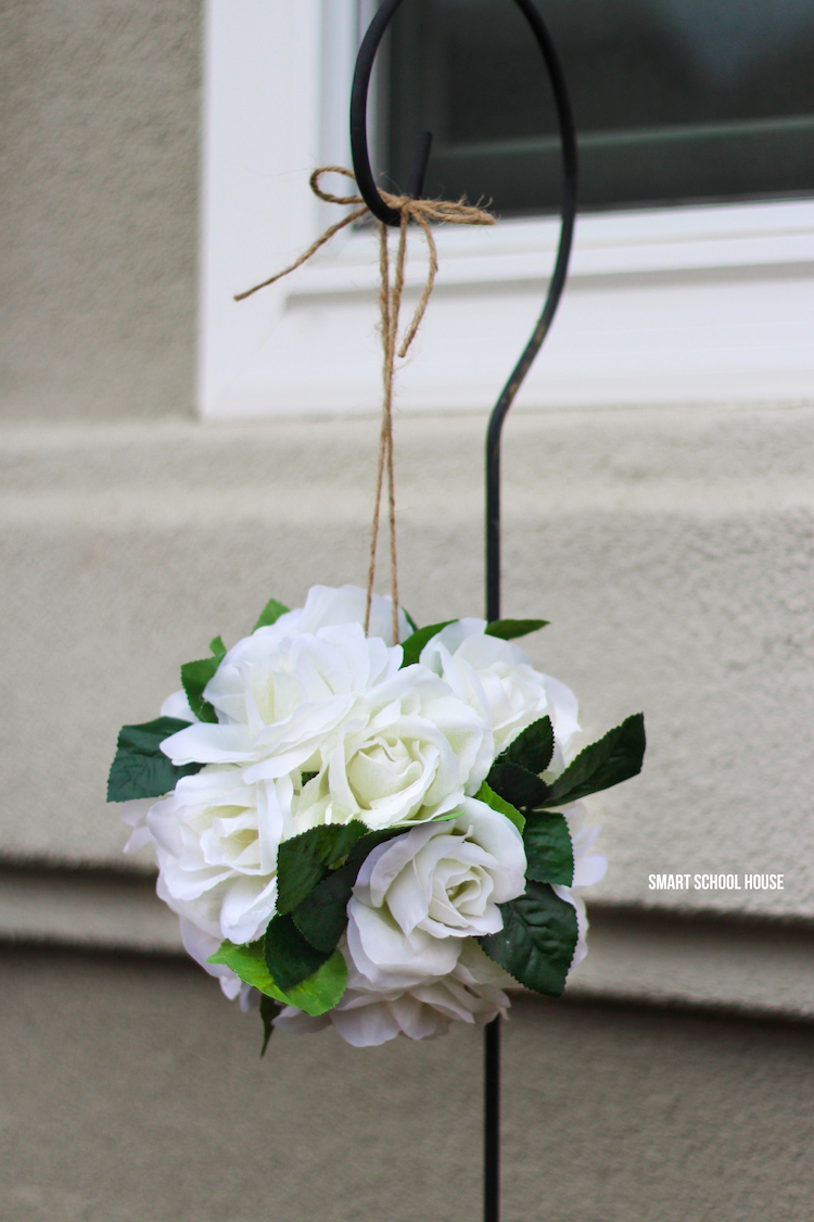 How to make hanging flower pomanders with wiffle balls in about 10 minutes!! Hang the roses around your home or use them for DIY wedding decor. Easy and stunning! These are also called flower kissing balls. You're never going to belive how quick and easy this DIY decor craft is.