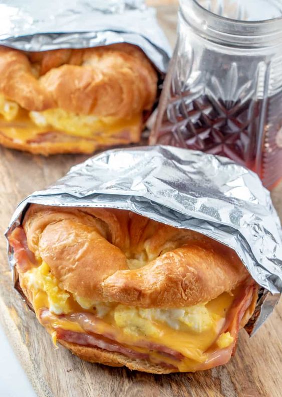 Croissant Breakfast Sandwiches - Flaky croissants are filled with ham, eggs and cheese and baked until golden and melty making these Easy Croissant Breakfast Sandwiches the prefect breakfast.