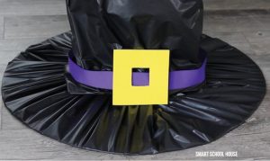 Cut a buckle out of yellow craft foam (the craft knife helps with this) and attach it to the hat using glue or duct tape