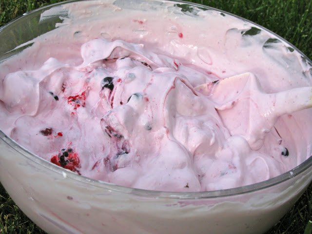 It's made of frozen berries, Cool Whip, vanilla yogurt, and cheesecake pudding mix. One person said, "Always a favorite whenever I bring it!"