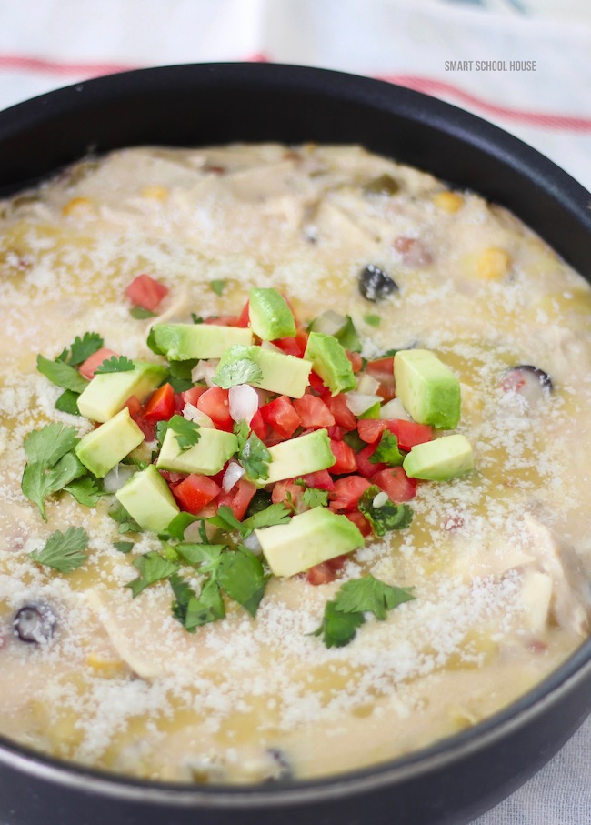 The flavor of an enchilada recipe made quickly in a skillet with torn corn tortillas, cooked chicken, zesty creamy sauce and cheese #skillet #enchiladas #enchiladarecipe #creamyenchiladas #onepandinner #quickdinner #easydinner