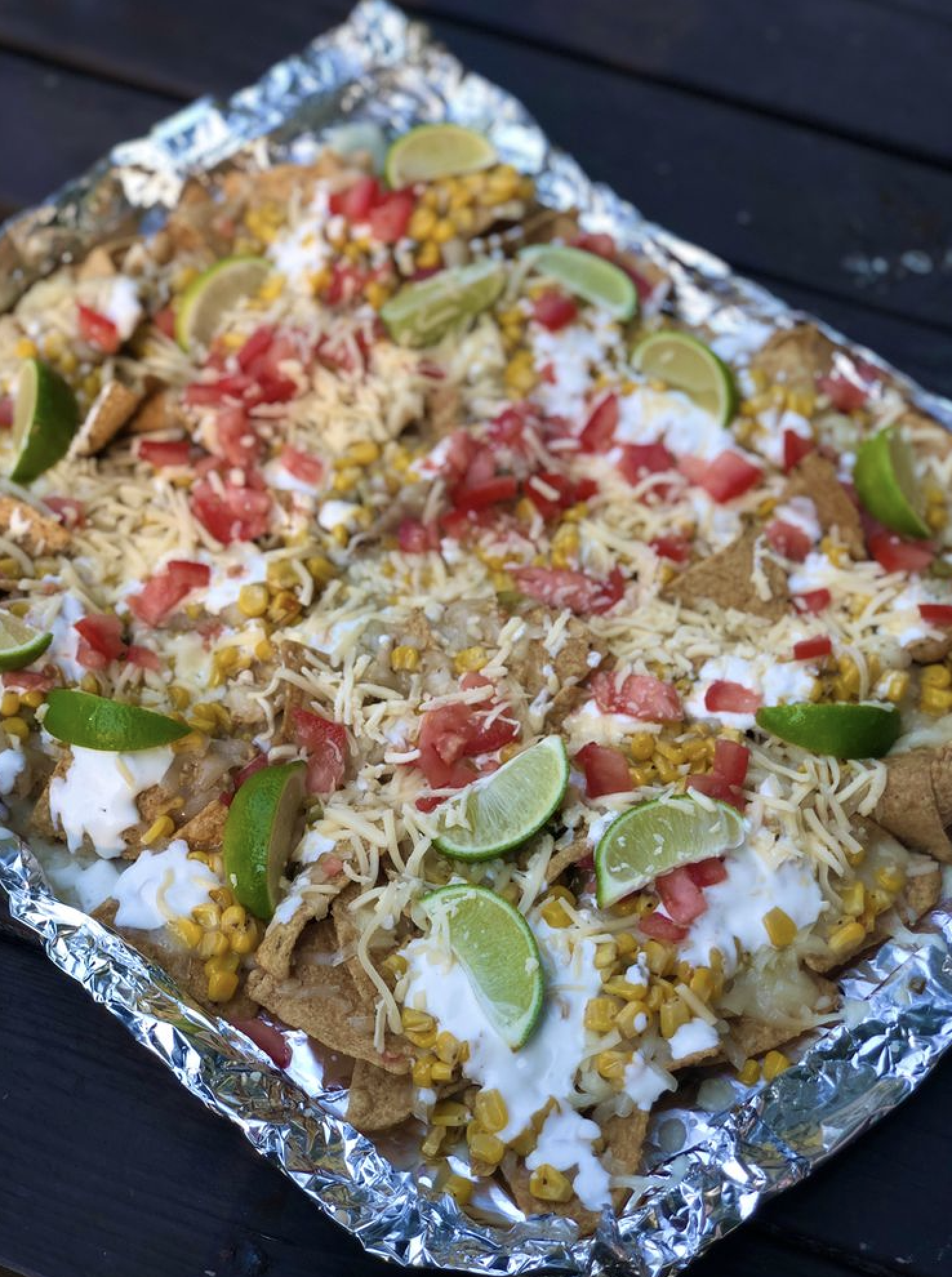 Everyone’s favorite Mexican elote is made into the BEST nachos! Loaded with roasted corn, lime, chili powder and Mexican crema!