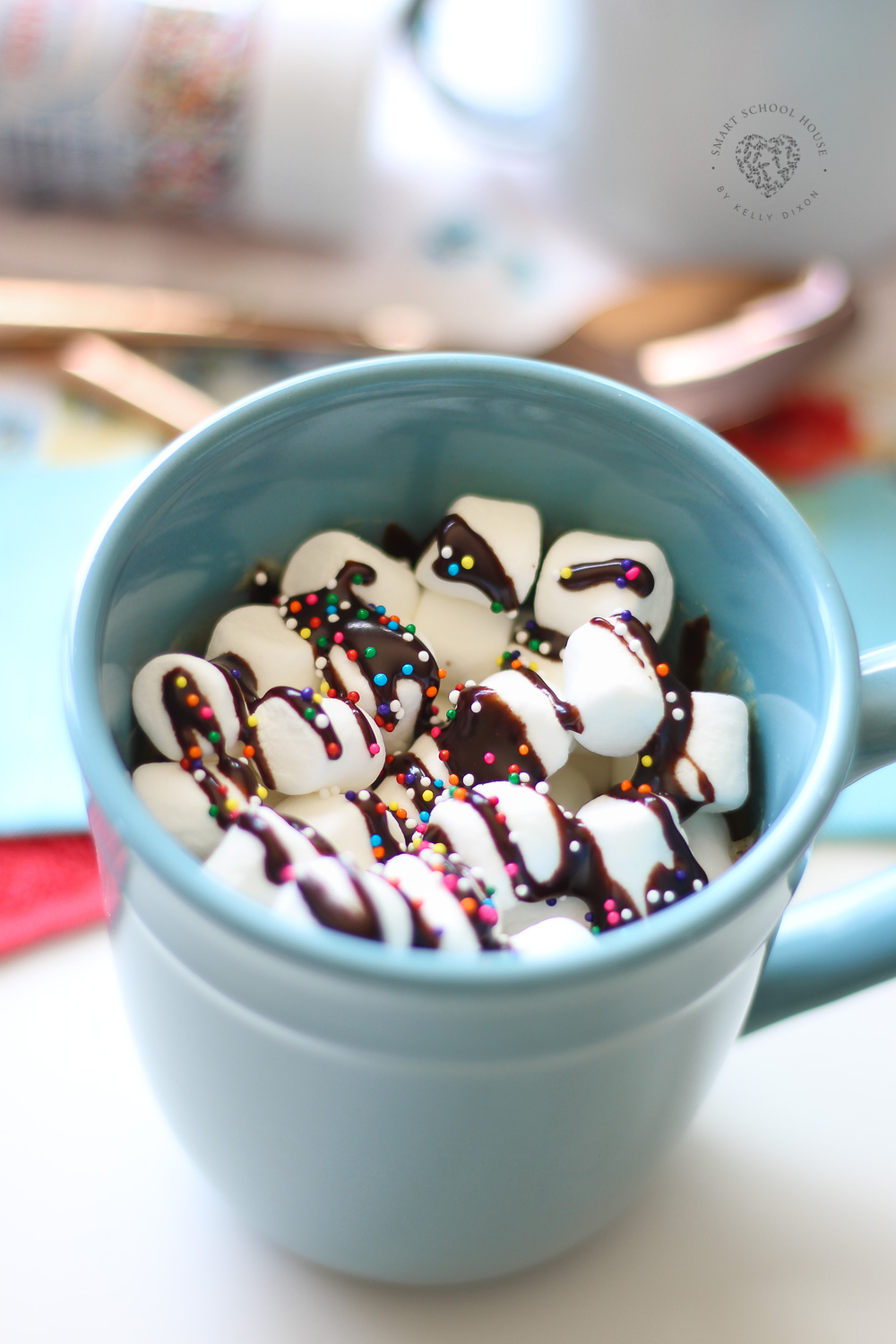 Chocolate Chip Cookie Mug Cake topped with marshmallows and sprinkles! If you have a mug, a microwave & a spoon you can make this in less than 2 minutes. 
