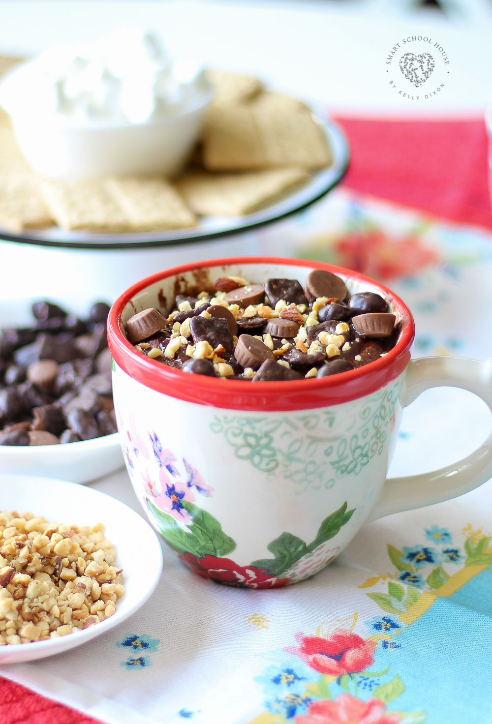 Hot fudge brownie microwave mug treat topped with nuts and peanut butter treats. YUM!