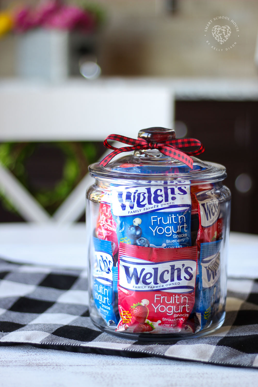 Fruit Snacks in a Jar - colorful fruit snack bags stacked in a clear jar for easy access and pretty organization of kids' snack food. 