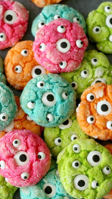Ooey Gooey Monster Eye Cookies Recipe - so good and perfect for Halloween! Yellow cake mix, cream cheese, & powdered sugar with green food coloring and a candy eye on top!
