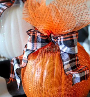 Pumpkins Wrapped in Mesh. A no-carve pumpkin decorating idea!I love how the pumpkins sparkle and look all dressed up without any carving. #pumpkindecor #decoratingwithpumpkins #DIYHalloweenDecorations #DecoMeshPumpkin