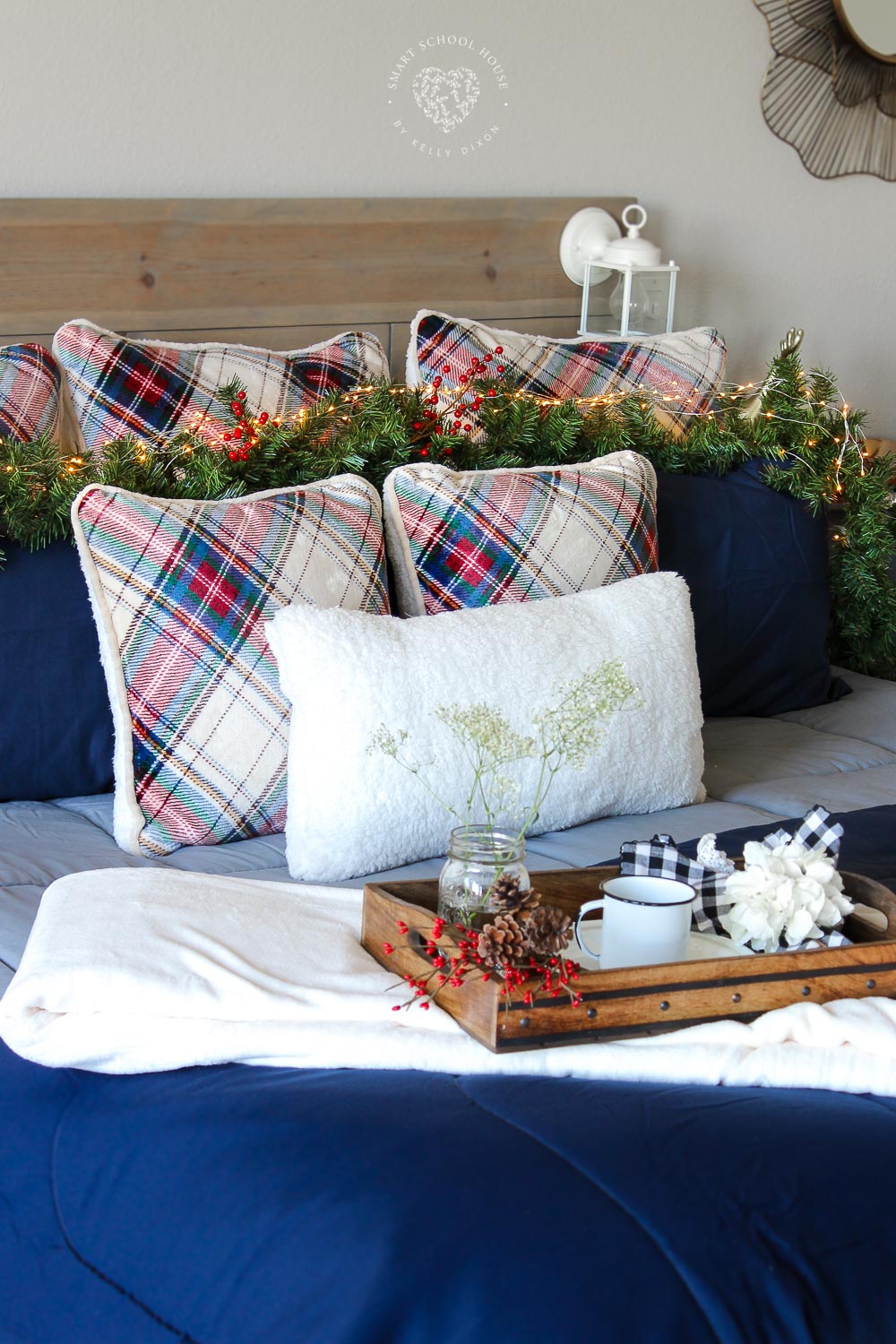 How to decorate a bed for the holidays. Plaid pillows, garland, lanterns, and fairy lights. Cozy Holiday Bedding. 