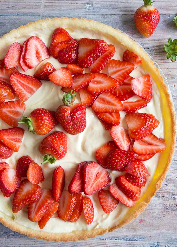 Strawberry mascarpone tart is a deliciously creamy and fruity low carb and keto dessert. The velvety whipped mascarpone filling is set off perfectly by the crisp baked coconut flour tart crust. #lowcarb #keto #sugarfree #strawberryshortcake 