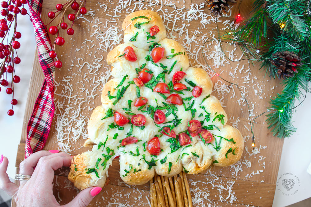 This tasty Christmas Tree Pull-Apart Bread is loaded with cheddar, mozzarella and other cheeses for a surprise in every warm, buttery, and garlicky bite.