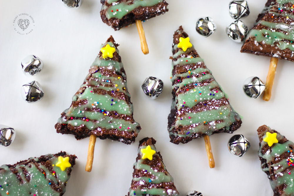 Brownies have never looked cuter! A simple brownie becomes extra special with the addition of drizzled green frosting, powdered sugar, and sprinkles. These easy chewy Christmas Brownie Trees are easy to make and add a beautiful touch to your Christmas table! Kids and adults alike will love these Christmas brownies! 