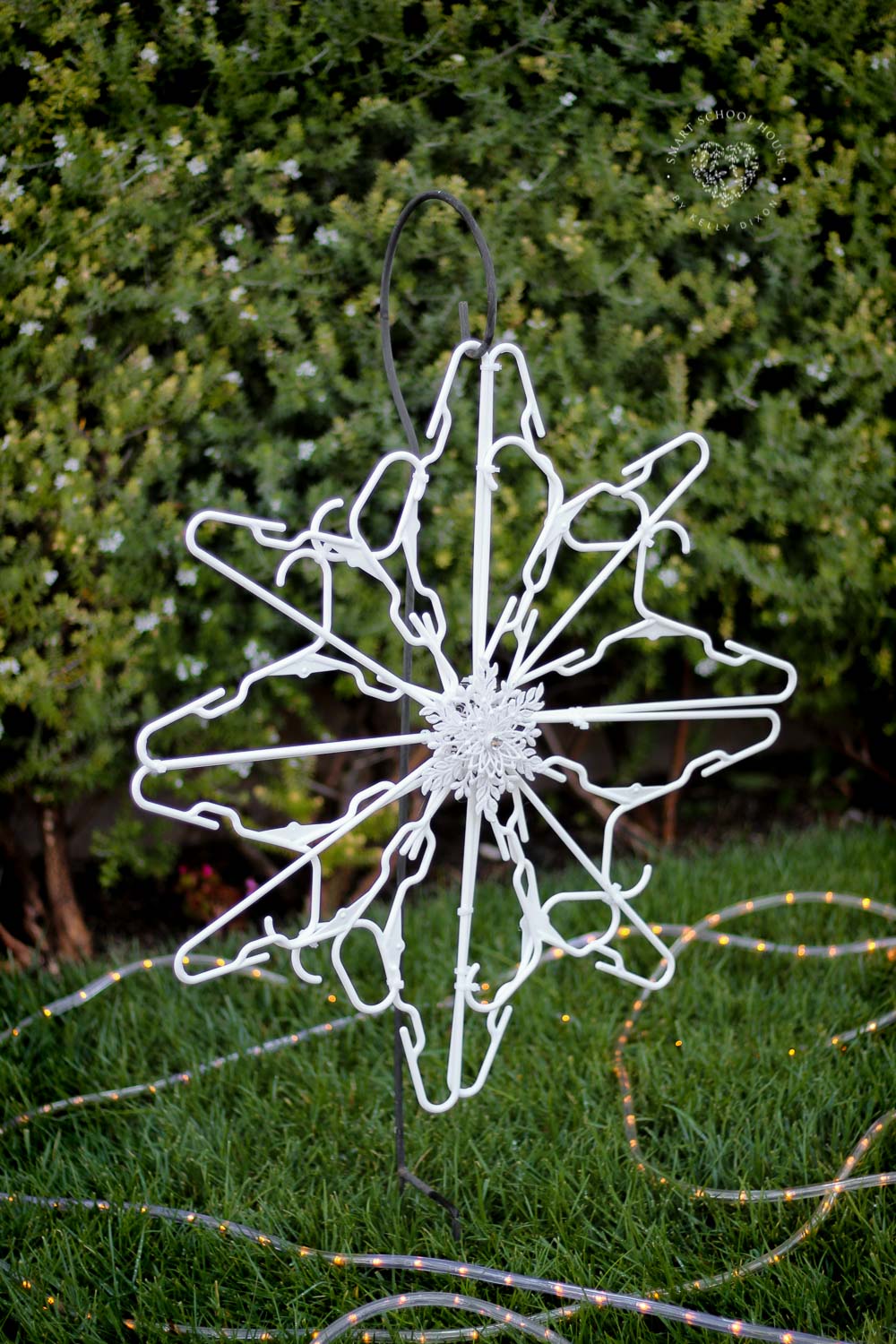 Use child size plastic hangers and zip ties to make a hanger snowflake! Decorate for the holidays with these beautiful DIY snowflakes made out of hangers.