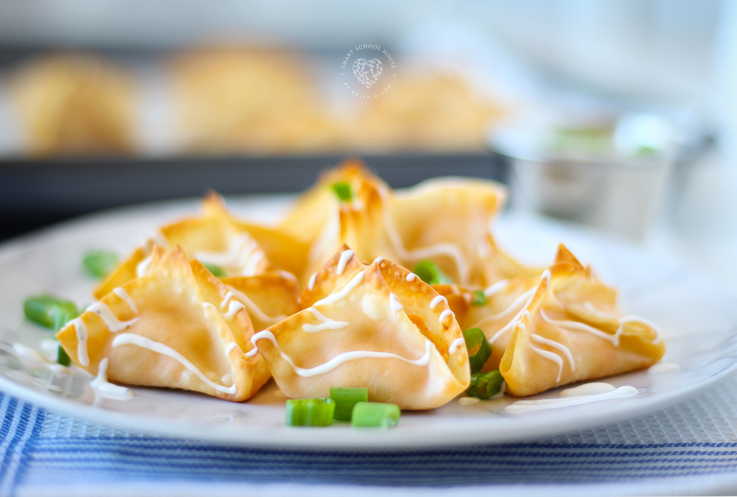 Buffalo Chicken Wontons. Baked, not fried! Creamy buffalo chicken drizzled in dressing! Done in 12 minutes. 