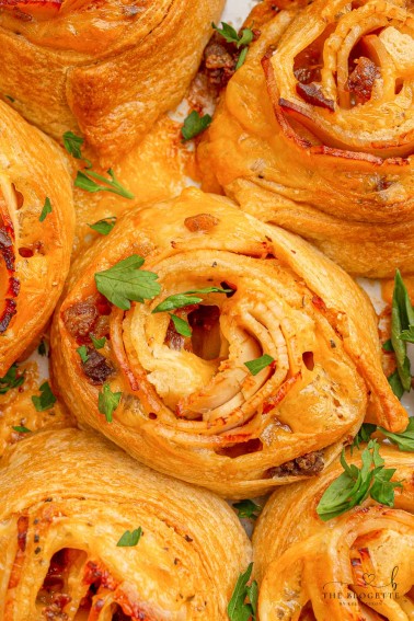 Baked Turkey and Cheese Rolls have melted cheese, bacon, and turkey covered in a garlic buttery glaze! The perfect party appetizer idea!