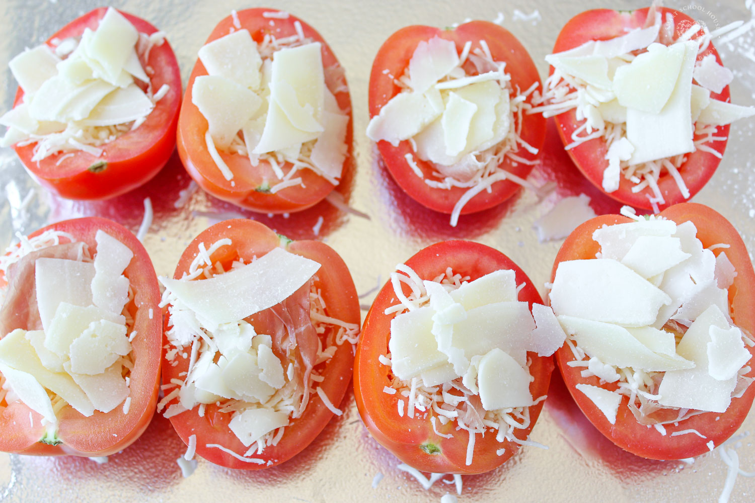 Tomatoes with mozzarella, shredded parmesan, and prosciutto