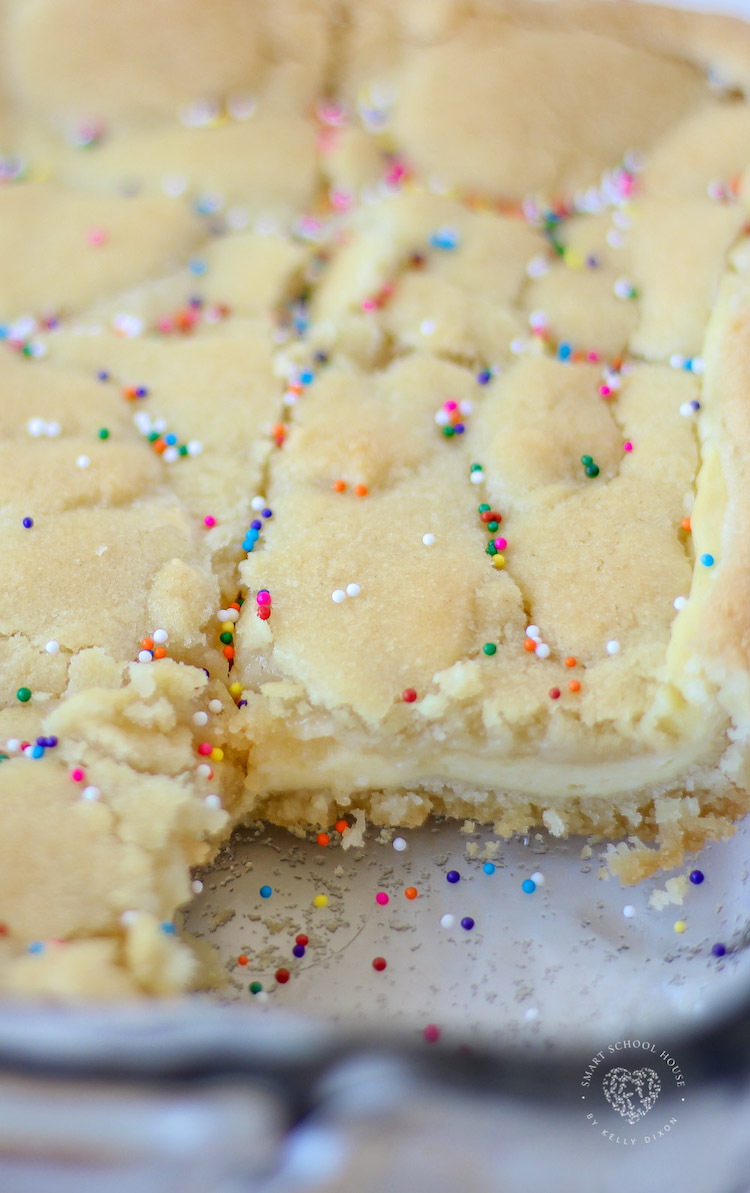 Sugar Cookie Cheesecake Bars - sugar cookie dough surrounding creamy cheesecake filling. A dessert that has the best of both worlds!