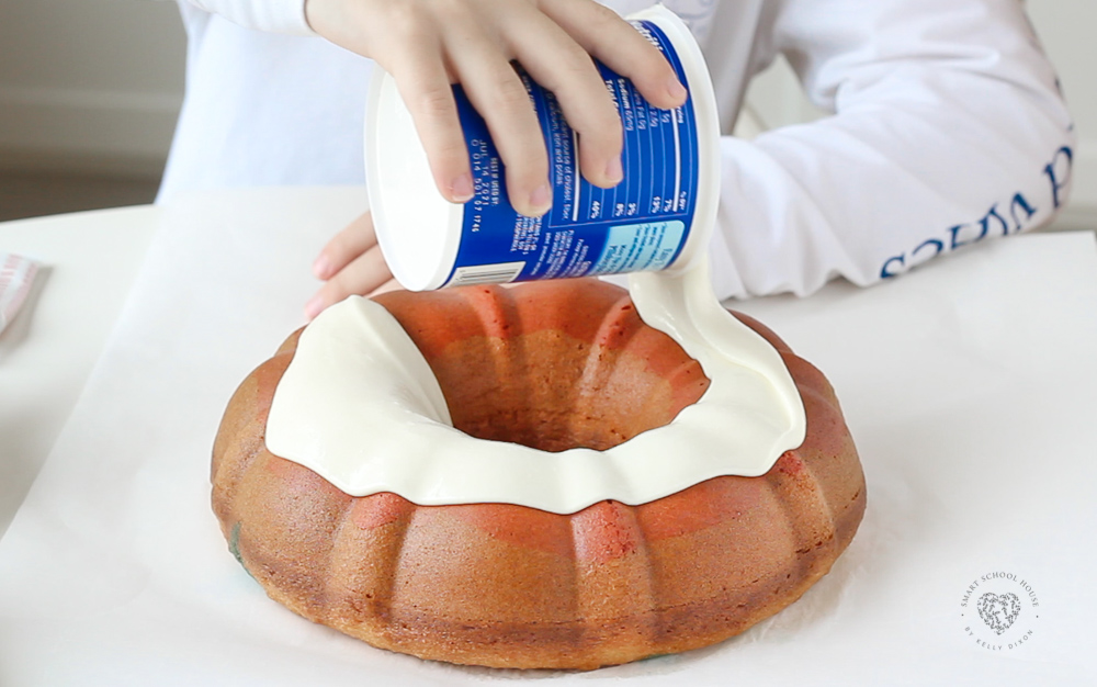 Pouring melted frosting on a cake