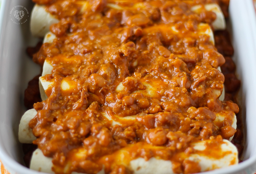 This Cheesy Chili Dog Casserole is pure comfort food. Hot dogs, chili, and cheddar cheese combined to make an easy and delicious meal. #hotdog #casserolerecipes