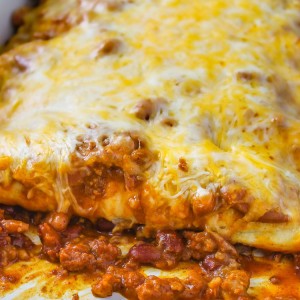 Chili Dog Casserole - 4 Ingredient easy, cheesy dish with hot dogs, chili, and beans. A quick and easy dinner recipe to make over and over again!