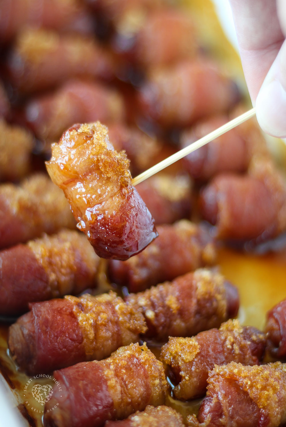 Little sausages wrapped in bacon and smothered in sweet brown sugar. An easy recipe for parties, game day, or potlucks! They are baked to mouthwatering golden brown perfection. These Little Smokies Wrapped in Bacon are so addictive, everyone loves them from kids to adults. What’s not to love here?