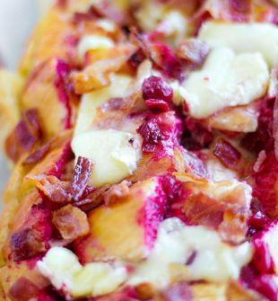 Whether planning recipes for holiday leftovers or planning appetizers for holiday get togethers, this Cheesy Bacon and Cranberry Pull Apart Bread recipe is a MUST have! It's cheesy, buttery, filled with bacon, and of course, festive cranberry sauce.