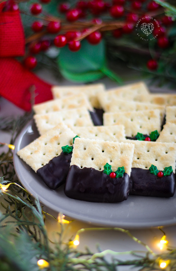 Christmas Crackers use your favorite old fashioned saltine cracker, dipped in chocolate, and adorned with holly sprinkles!