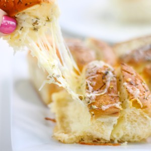 This Cheesy Hawaiian Garlic Bread will literally change your life. So much so that daughter requests this cheesy pull-apart bread for her birthday. This recipe is seriously that delicious!