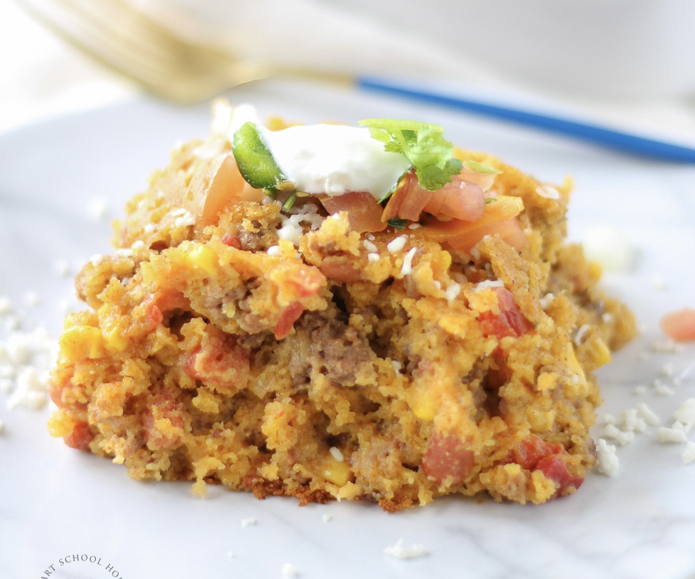 Cowboy Cornbread Casserole layers ground beef, beans, corn, cheese, and cornbread batter into a hearty meal that everyone loves!