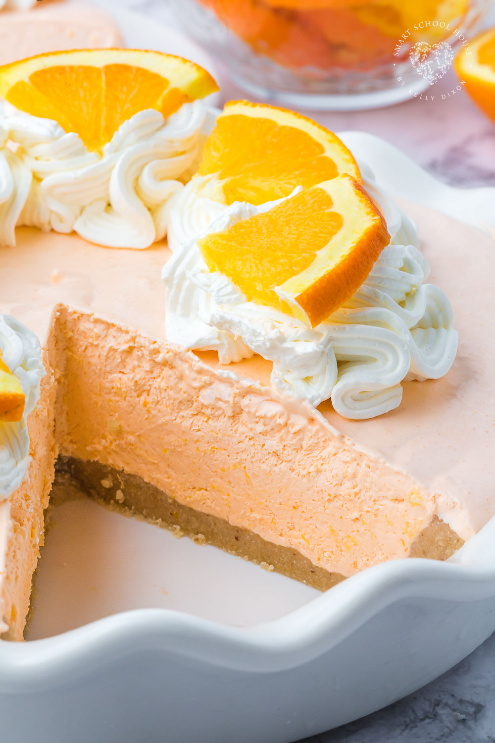 An Orange Jello Creamsicle Pie is an orange popsicle with an irresistible creaminess, all in a cookie pie crust. It screams hot summer days and ice cream trucks! 