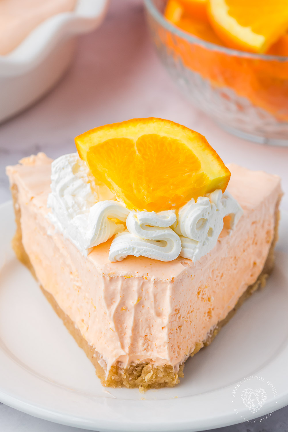 An Orange Jello Creamsicle Pie is an orange popsicle with an irresistible creaminess, all in a cookie pie crust. It screams hot summer days and ice cream trucks! 