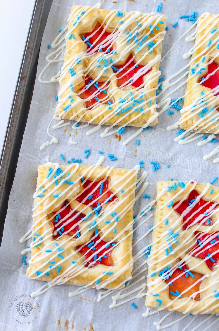 This strawberry Patriotic Puff Pastry is the perfect 4th of July or Memorial Day dessert with blue sprinkles and white chocolate drizzle.