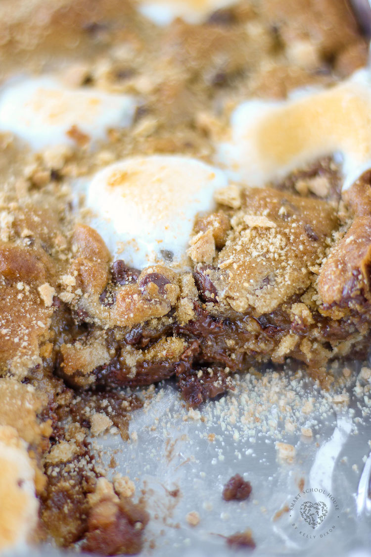 S'mores Cookie Bars - chocolate chip cookie dough, graham crackers, marshmallows, and chocolate bars create ooey-gooey cookie bars! You can enjoy this any time of year because there's no campfire required.