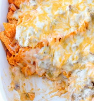 This Dorito casserole is layers of crushed Dorito chips, ground beef, and an ooey-gooey cheese sauce. It all gets baked together to melted cheese perfection.