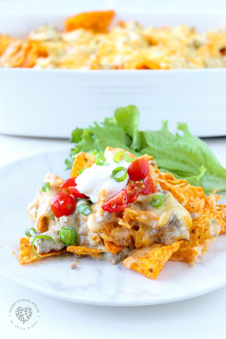 This Dorito casserole is layers of crushed Dorito chips, ground beef, and an ooey-gooey cheese sauce. It all gets baked together to melted cheese perfection.