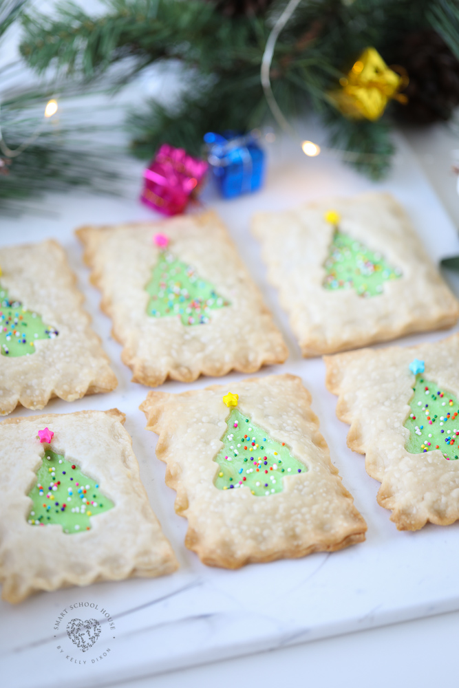 My Christmas Tree Hand Pies are as adorable as it gets! These little handheld pies are filled with delicious cheesecake and surrounded with pie crust and adorned with sprinkles that look like Christmas lights. This holiday dessert idea is sure to get everyone's attention!